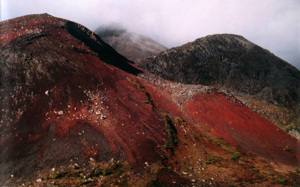 Reddish scoria and ash forms the surface of the Ulug-Arginsky scoria cone, located about 200 km WNW of the SW tip of Lake Baikal. The red color is from oxidation when the clasts were erupted at high temperatures. Photo by Sergei Arzhannikov, 1997 (Siberian Branch, USSR Academy of Sciences).