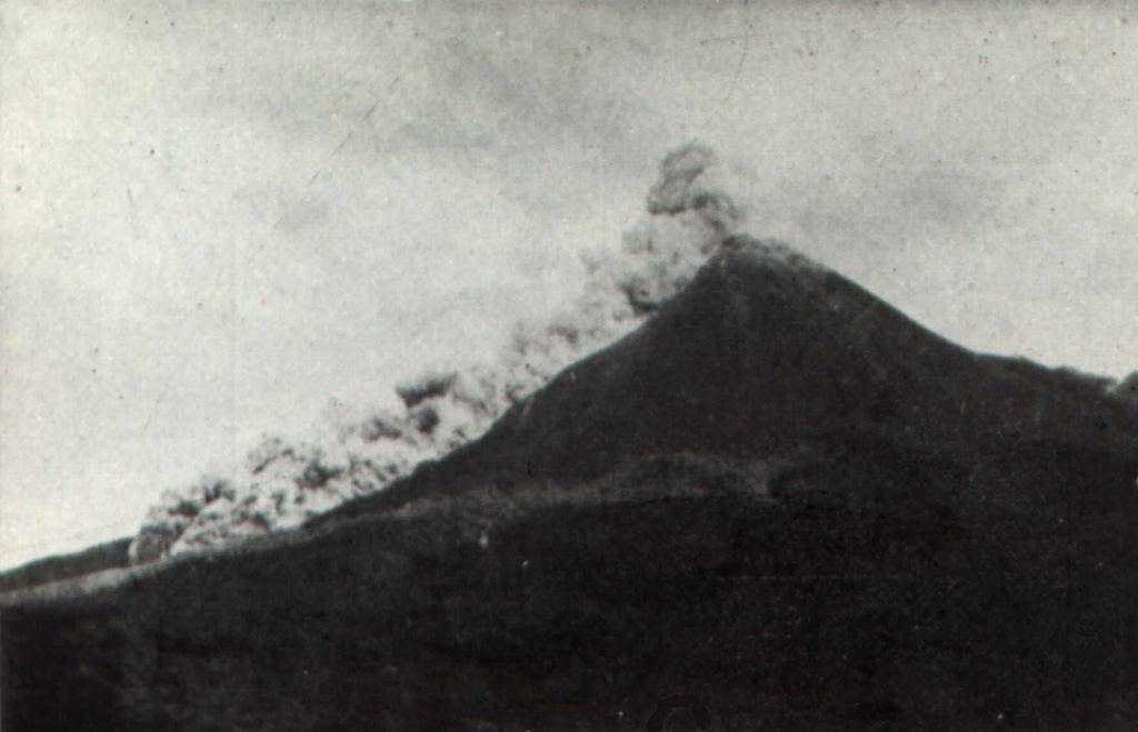 A pyroclastic flow traveling down the SW flank of Merapi volcano is seen from the Plawangan Observatory on 12 April 1967. Explosive eruptions, pyroclastic flows, and lava dome growth took place during 1967-70. Eruptive activity began on 12 January 1967. Paroxysmal phases took place on 7-9 October 1967 and 8 October 1968, during which partial collapse of the lava dome produced frequent pyroclastic flows (block-and-ash flows). The velocity of the pyroclastic flow seen in this photo was estimated by the Volcanological Survey of Indonesia to be 60 km/hour. Photo by I. Suryo, 1967 (Volcanological Survey of Indonesia).