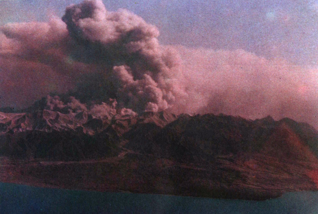 A broad ash plume rises above Colo volcano on the island of Una-Una during the powerful 1983 eruption.  Phreatic eruptions began on July 18.  All inhabitants of the island were evacuated prior to the paroxysmal eruption at 1623 hrs on July 23, when pyroclastic flows devastated most of the island.  Intermittent large explosive eruptions, some producing pyroclastic flows, continued until August 30, and minor ash eruptions lasted until October 10.  White and sometimes gray "smoke" was reported November-December, presumably from phreatic eruptions. Photo courtesy of Volcanological Survey of Indonesia, 1983.
