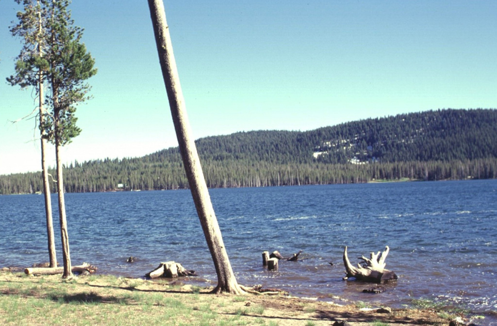 Medicine Lake, a popular camping and recreation destination in northern California, is a small 2-km-long lake that occupies the SW side of Medicine Lake caldera.  The forested southern rim of the 7 x 11 km caldera forms the horizon.  Medicine Lake volcano is known for its young obsidian flows within the caldera and on its flanks. Photo by Lee Siebert, 1988 (Smithsonian Institution).