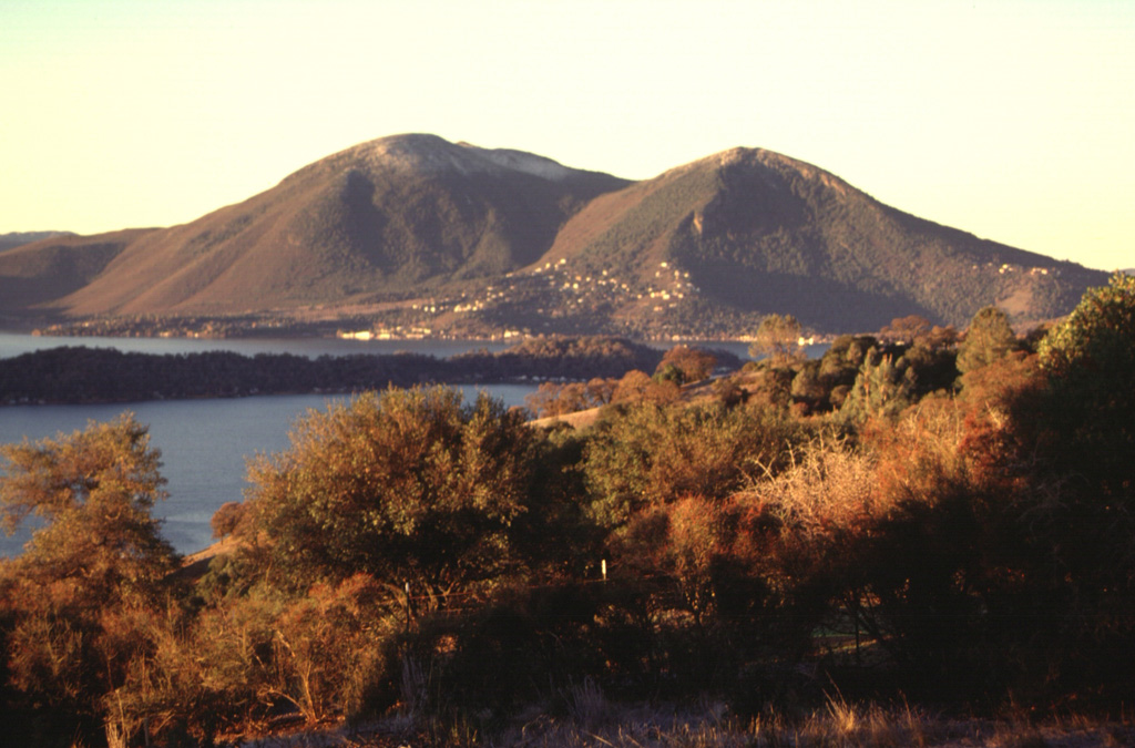 Mount Konocti, seen here beyond the southern shore of Clear Lake, is the largest feature of the Clear Lake volcanic field in the northern California Coast Ranges. The volcanic field contains lava dome complexes, scoria cones, and maars. It is located far to the west of the Cascade Range. Photo by Lee Siebert, 1997 (Smithsonian Institution).