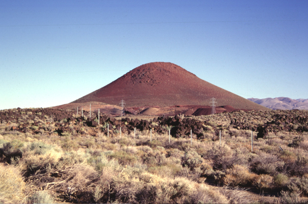 Red Cone, a basaltic cinder cone at the western margin of the Coso volcanic field, is a prominent landmark visible from Highway 395, which follows the eastern margin of the Sierra Nevada Range.  The late-Pleistocene cinder cone is the largest of a group of isolated cones along the valley floor.  An area of more concentrated young basaltic cones and lava flows occurs to the SE along the crest of the volcanic horst forming the Coso Range. Photo by Paul Kimberly, 1997 (Smithsonian Institution).