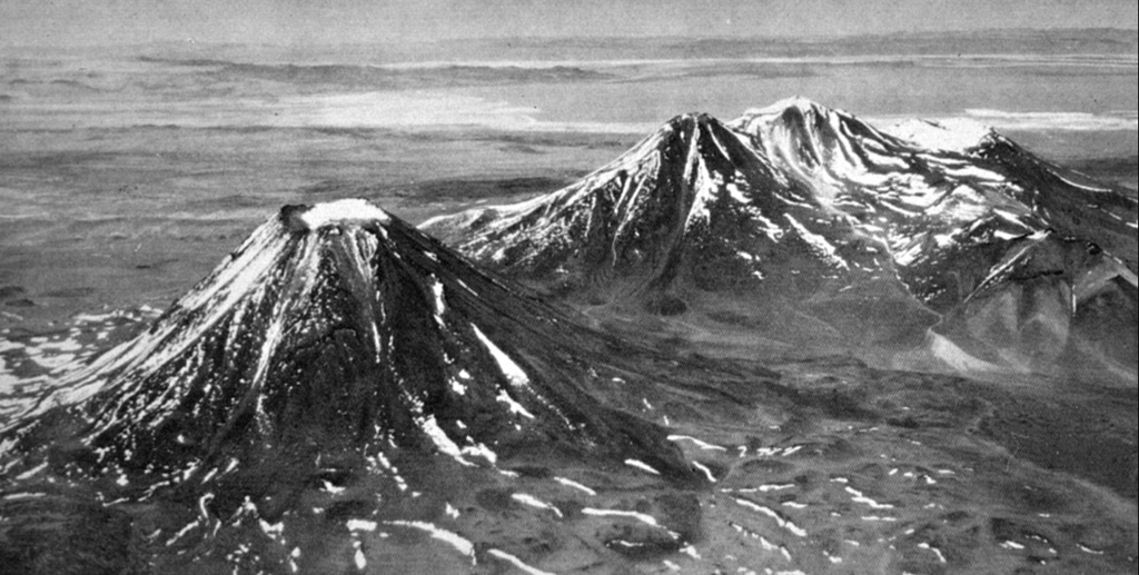 Volcán Chiliques, the conical peak at the left, is a structurally simple stratovolcano located immediately south of Laguna Lejía.  A 500-m-wide snow-capped crater truncates the summit and contains a small lake.  The volcano was constructed over a base of dacitic lava domes and andesitic lava flows.  Youthful lava flows radially descended from the summit as far as 5 km to the NW.  The volcanic complex at the right is the Pleistocene Volcán Lejía, which was constructed within a 3.5-km-wide caldera. Photo by Instituto Geográfico Militar, courtesy of Oscar González-Ferrán (University of Chile).