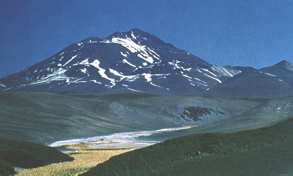 The world's highest historically active volcano, 6739-m-high Llullaillaco, sits astride the Chile-Argentina border.  The summit, seen here from the NE, is formed by a smaller well-preserved cone that was constructed on an older edifice dating back to the early Pleistocene.  A major debris-avalanche deposit produced by collapse of the older volcano extends eastward into Argentina.  Growth of the modern cone was completed with the emplacement of a series of young lava flows down the northern and southern flanks.   Photo by Carlos Felipe Ramírez, courtesy of Oscar González-Ferrán (University of Chile).