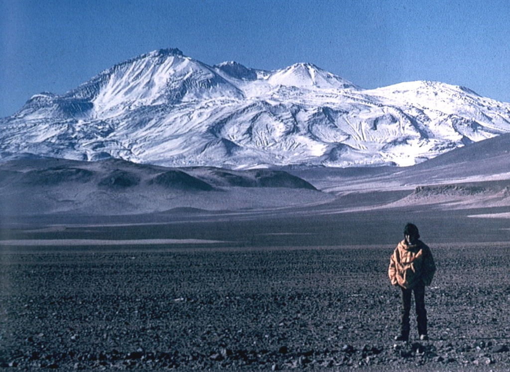 The world's highest Holocene volcano, Nevados Ojos del Salado, rises to 6887 m along the border between Chile and Argentina.  The summit complex, which is elongated in a NE-SW direction, is seen here from the NW.  The  massive volcanic complex contains numerous craters, cones, and andesitic and dacitic lava domes.  No historical eruptions have been recorded, but the volcano is fumarolically active.   Photo by Oscar González-Ferrán (University of Chile).