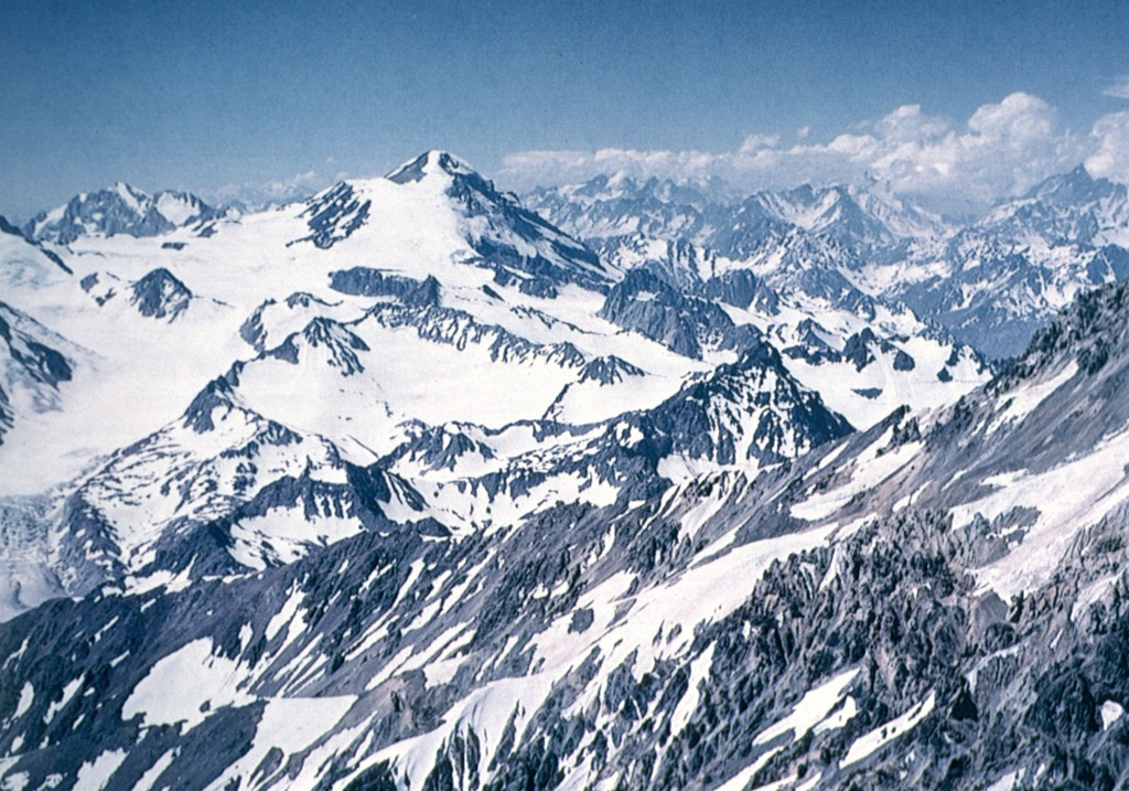 Glaciers mantle the southern side of 4850-m-high Palomo volcano (left-center).  The ice cover forms the Universidad (University) Glacier, which drains to the SW into the Tinguiririca River. Photo by Wolfgang Foerster, courtesy of Oscar González-Ferrán (University of Chile).