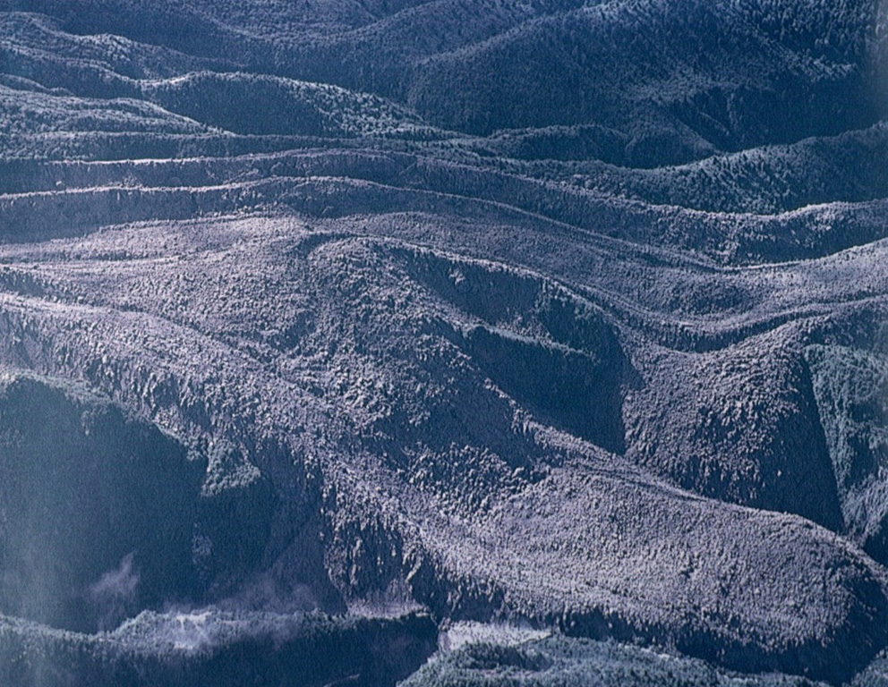 A blocky andesitic lava flow traveling at an average velocity of 4 meters per hour descended the Río Tepu valley on the NE flank of Calbuco during the 1961 eruption.  Explosions and lava effusion began on February 1, and lahars caused extensive damage on the north flank, where they reached Lake Llanquihue.  Lava flows traveled to the NE, NW, and SW, and a large explosion took place on March 10. Photo by Oscar González-Ferrán, 1961 (University of Chile).