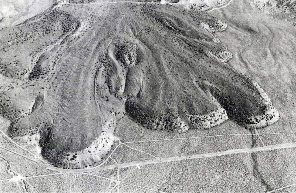 The Lava Park lava flow erupted about 9,300 years ago from a vent on the flank of Shastina, on the NW flank of Mount Shasta. The basaltic-andesite flow is about 6 km long and 110 m thick at the terminus. It overlies a wide apron of pyroclastic flow deposits emplaced about 9,700 years ago. The area shown is about 2 km wide and Highway 97 is seen near the bottom. Photo by Dan Miller, 1980 (U.S. Geological Survey).