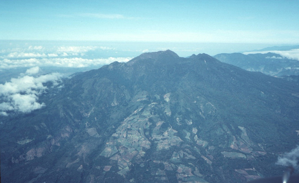This photo shows Volcán Barú from the ESE. The summit lava dome complex appears beyond the back wall of a large collapse scarp that forms an irregular ridge near the summit. The flat-topped edifice beyond Barú to the right (NW) is the Pleistocene Volcán Colorado.  Photo by Tom Casadevall, 1994 (U.S. Geological Survey).