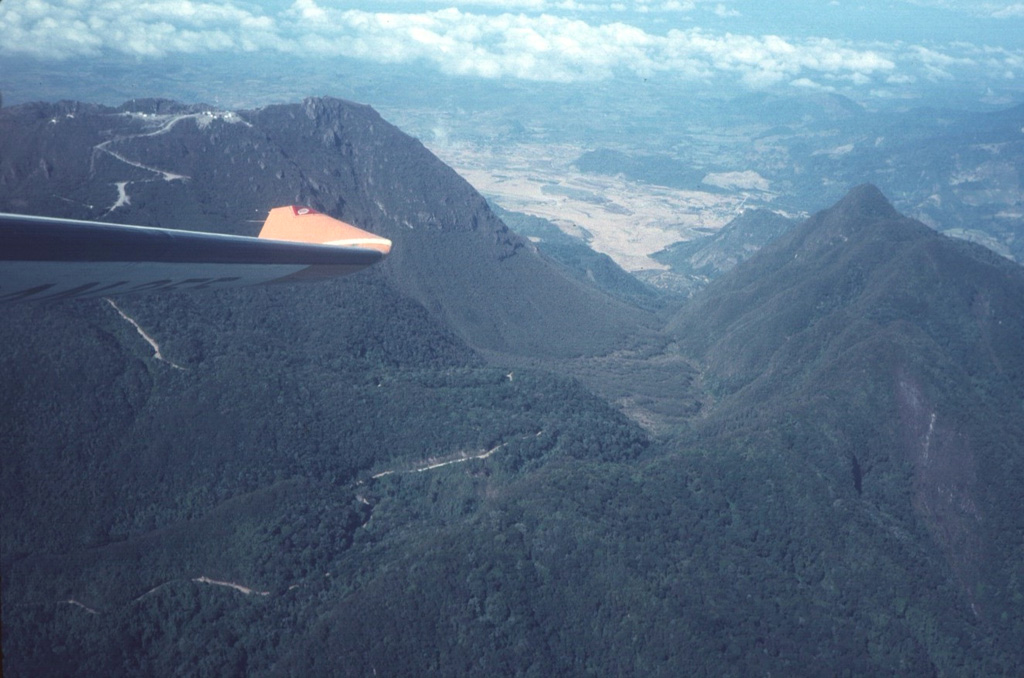 The outer eastern flanks of the large Volcán Barú collapse scar are in the foreground, with the northern scarp forming the ridge to the right. The road to the left crosses over the scarp into its moat and then up to the top of a post-collapse lava dome complex that forms the summit. Photo by Tom Casadevall, 1994 (U.S. Geological Survey).