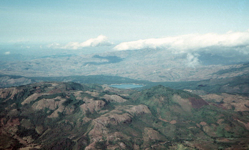 La Yeguada volcanic complex is in the foreground with Laguna La Yeguada (center) to the west. This massive volcanic center, also known as Chitra-Calobre, lies in west-central Panamá. El Castillo dome (left) is the high point of the complex, and Cerro Corero de la Charca (right) is a late-Pleistocene lava dome.  Photo by Tom Casadevall, 1994 (U.S. Geological Survey).