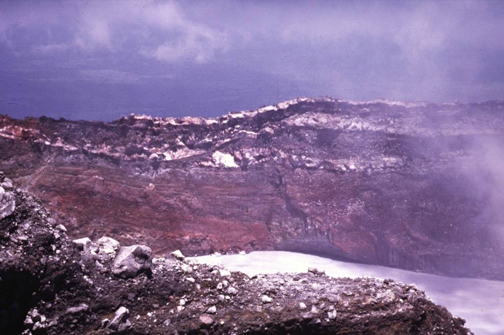 The walls of Cráter Activo expose thick sequences of oxidized and hydrothermally altered pyroclastic deposits and lighter lava flows. Many eruptions from Active Crater have originated from vents beneath the acidic crater lake. Photo by Guillermo Alvarado (Instituto Costarricense de Electricidad).