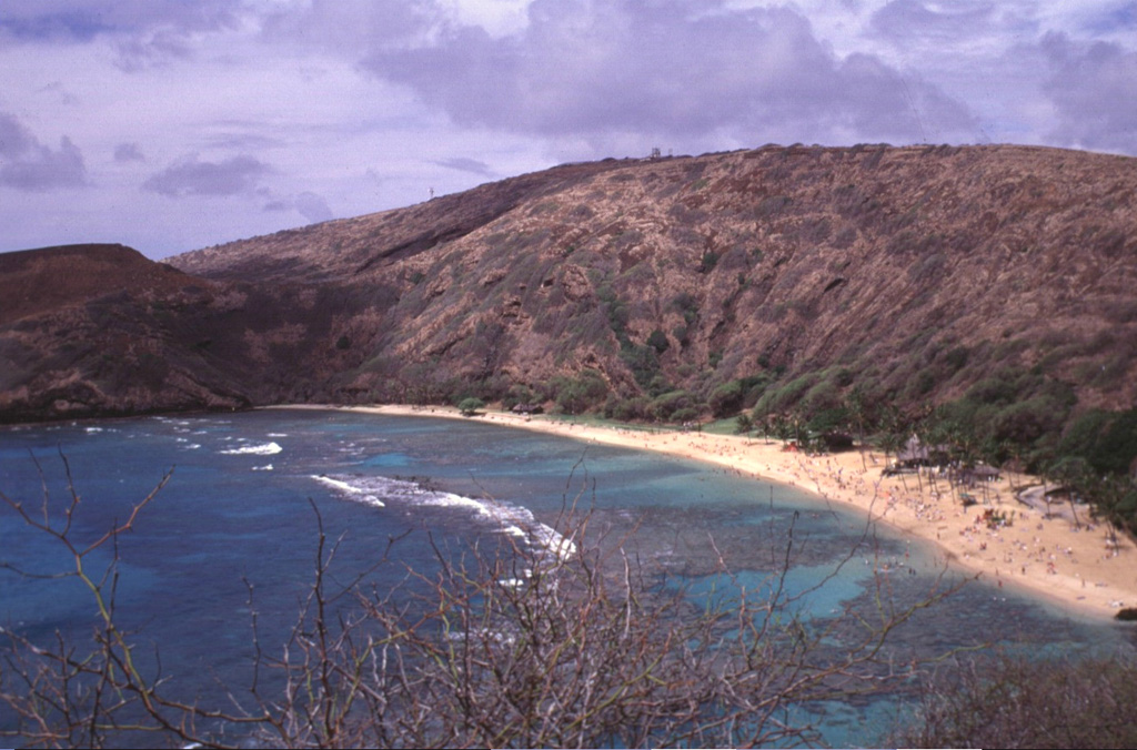 Hanauma Bay partially fills a breached crater near the SE tip of the island of Oahu.  The crater is part of the Honolulu Series, a group of late-Pleistocene and possibly Holocene tuff cones, cinder cones, and spatter cones (many with associated lava flows) constructed on the eastern flank of the massive Koolau shield volcano.  This elongated shield volcano is of Pliocene-to-Pleistocene age and forms much of the eastern half of Oahu.   Photo by Lee Siebert, 1998 (Smithsonian Institution).