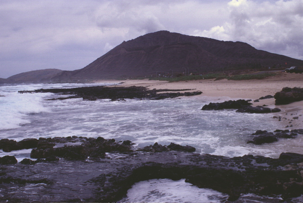 Koko crater, rising above the eastern coast of Oahu, is one a group of tuff cones and satellitic vents of late-Pleistocene to possible Holocene age on the eastern flank of the massive Koolau shield volcano.  This elongated shield volcano of Pliocene-Pleistocene age forms much of the eastern half of Oahu.  Koko crater is part of the Honolulu Series, a group of tuff cones, cinder cones, and spatter cones, many with associated lava flows. Photo by Lee Siebert, 1997 (Smithsonian Institution).