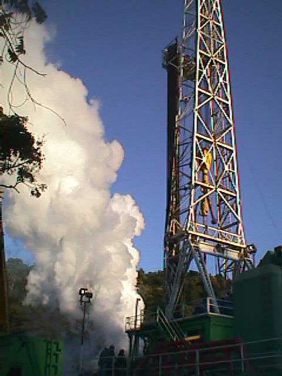 A drill rig towers above a well site at the Berlín geothermal area.  The first exploratory well at Berlín was drilled in 1966 by the government of El Salvador, with assistance from the United Nations.  Feasibility studies in the early 1980s were halted by the civil war, and production testing of wells was not completed until 1987.  The first two 5 MW power plants came on line in 1992, and 25 MW wells at the Berlín 2 site went into operation in 1998 and 1999. Photo courtesy of Comisión Ejecutiva Hidroeléctricia del Río Lempa (CEL).