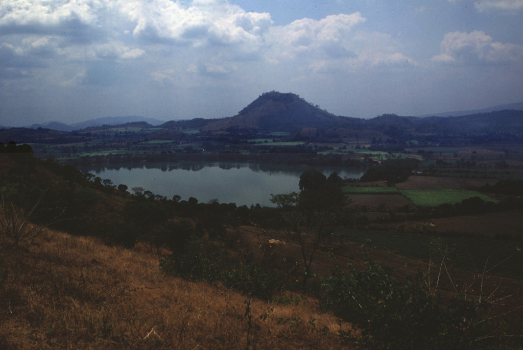 Cerro El Cerrón, one of the largest lava domes of the Apastepeque volcanic field, is seen here beyond Laguna de Apastepeque.  Photo by Giuseppina Kysar, 1999 (Smithsonian Institution).