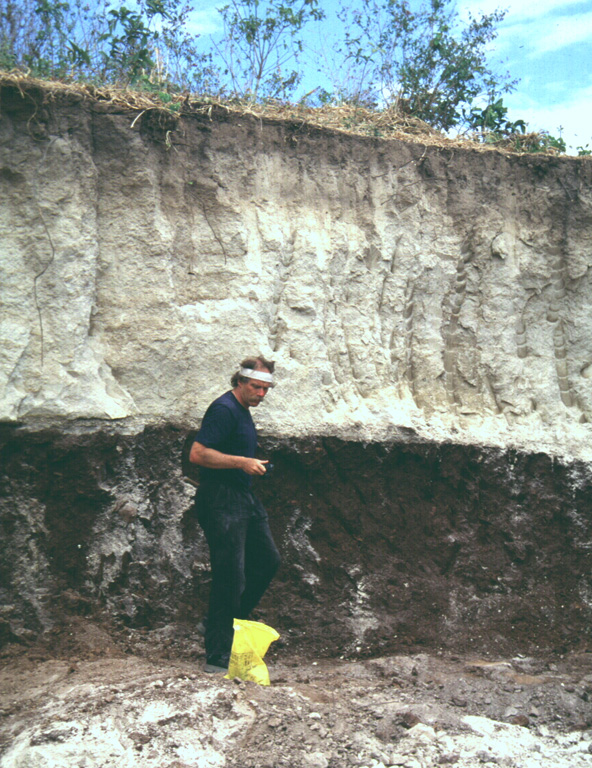 Volcanologist Jim Vallance samples the TB3 (Tierra Blanca 3) deposit, the second oldest of four major deposits associated with the formation of Ilopango caldera. This outcrop is located south of the town of Panchimalco, about 20-30 km SW of the caldera. Photo by Carlos Pullinger, 1996 (Servicio Nacional de Estudios Territoriales, El Salvador).