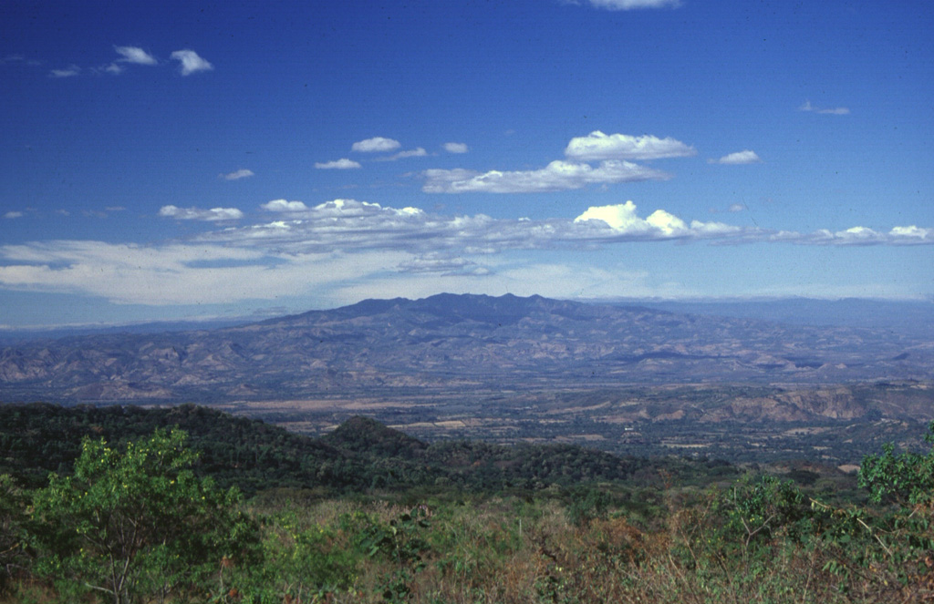 The broad massif of Cerro Cacahuatique lies in the interior valley of El Salvador about 30 km NNE of San Miguel volcano.  The massive 1500-m-high Pleistocene stratovolcano (also spelled Cerro Cacaguatique) rises 1000 m above its base and is deeply dissected, although it still retains its subdued conical form.  A large erosional caldera, formed through a breach on the SE side, truncates the summit.   Photo by Carlos Pullinger, 1999 (Servicio Nacional de Estudios Territoriales, El Salvador).
