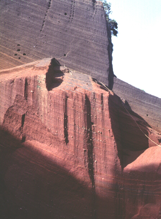 Oxidized red scoria deposits are exposed in a quarry on Cerro el Cerrito, a scoria cone on the lower northern flank of San Salvador immediately SE of the town of Quezaltepeque. Photo by Carlos Pullinger, 1996 (Servicio Nacional de Estudios Territoriales, El Salvador).