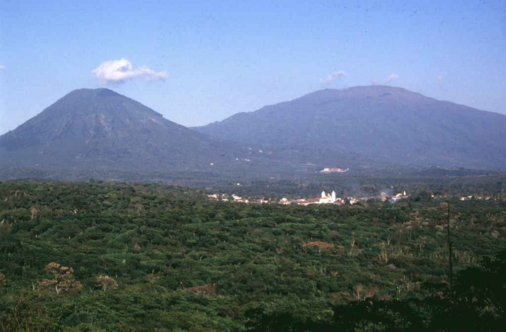 Two volcanoes rise above the town of Juayua in western El Salvador. The peak to the left is Cerro los Naranjos, one of the youngest peaks of the Apaneca Range volcanic complex. The broader peak to the right is Santa Ana. Santa Ana has produced recent eruptions from both summit and flank vents. Photo by Carlos Pullinger, 1996 (Servicio Nacional de Estudios Territoriales, El Salvador).