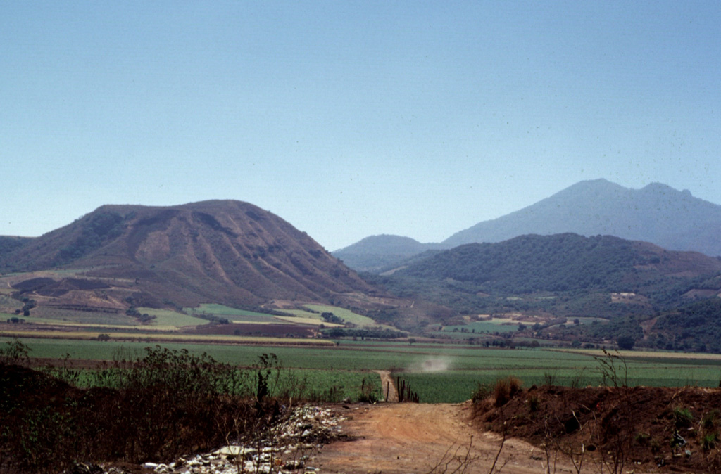 Volcán el Molcajete (left) is the largest scoria cone on the NW flank of Sangangüey volcano (upper right). The crater opens to the NW and was the source of a lava flow that traveled across the floor of the Tepic valley. Photo by Jim Luhr, 1999 (Smithsonian Institution).