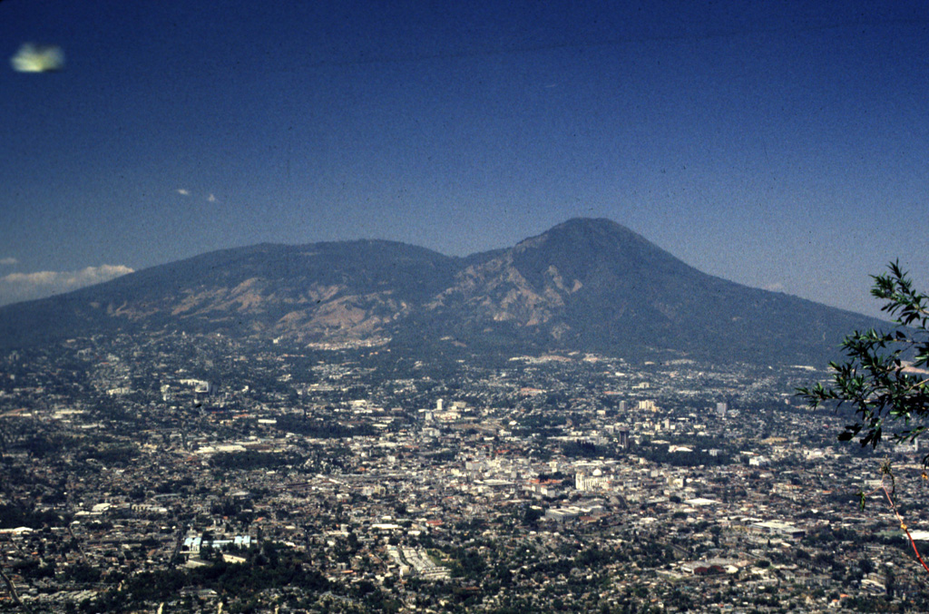 San Salvador volcano rises above the capital city of El Salvador. The broader peak to the left is the Boquerón edifice, which has grown within the 6-km-wide crater of the older El Picacho edifice (the peak to the right). Most of the four pre-1917 eruptions recorded at San Salvador since the 16th century have occurred at flank vents. Photo by Rick Wunderman, 1999 (Smithsonian Institution).