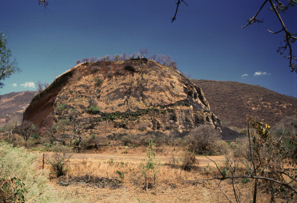 Cerro Quemado scoria cone near of the outlet of Lake Güija has been extensively quarried, and only a remnant remains. The San Diego volcanic field is along the El Salvador/Guatemala border and contains numerous scoria cones and associated lava flows on both sides of Lake Güija. Photo by Giuseppina Kysar, 1999 (Smithsonian Institution).