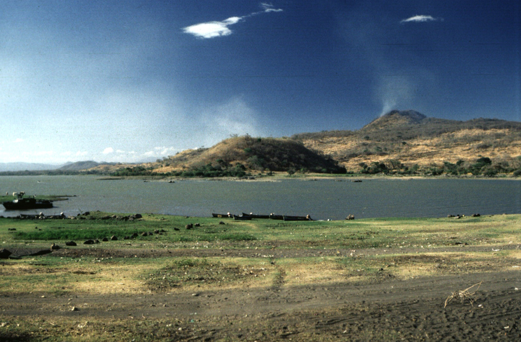 An extensive volcanic field of scoria cones and lava flows near Lake Güija is named after its largest feature, Volcán de San Diego (upper right). A large lava flow from the San Diego scoria cone dammed the drainage and was responsible for the formation of 12-km-long Lake Güija, which lies mostly in El Salvador and extends across the border into Guatemala. Cerro el Tule scoria cone in the center of the photo is near the eastern shore of the lake. Photo by Giuseppina Kysar, 1999 (Smithsonian Institution).