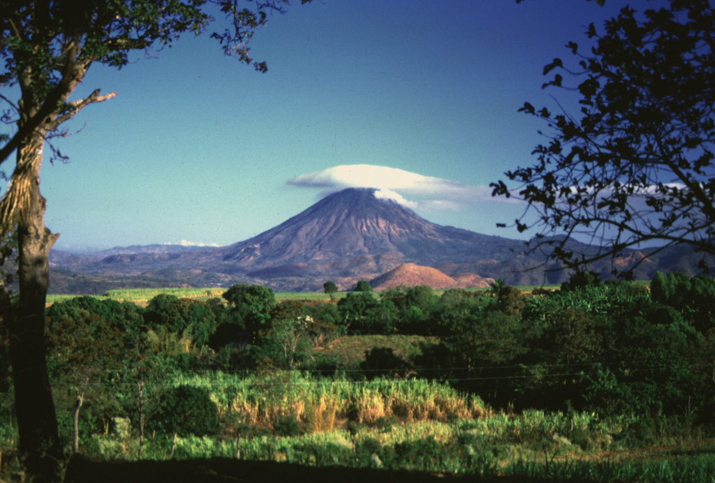 Volcán Chingo is located on the Guatemala/El Salvador border, seen here from the SE on the Salvador side of the border. The light-brown hill below is Cerro Laguneta. Other flank vents are located on the NE side and several recent lava flows are to the west and north. Photo by Giuseppina Kysar, 1999 (Smithsonian Institution).
