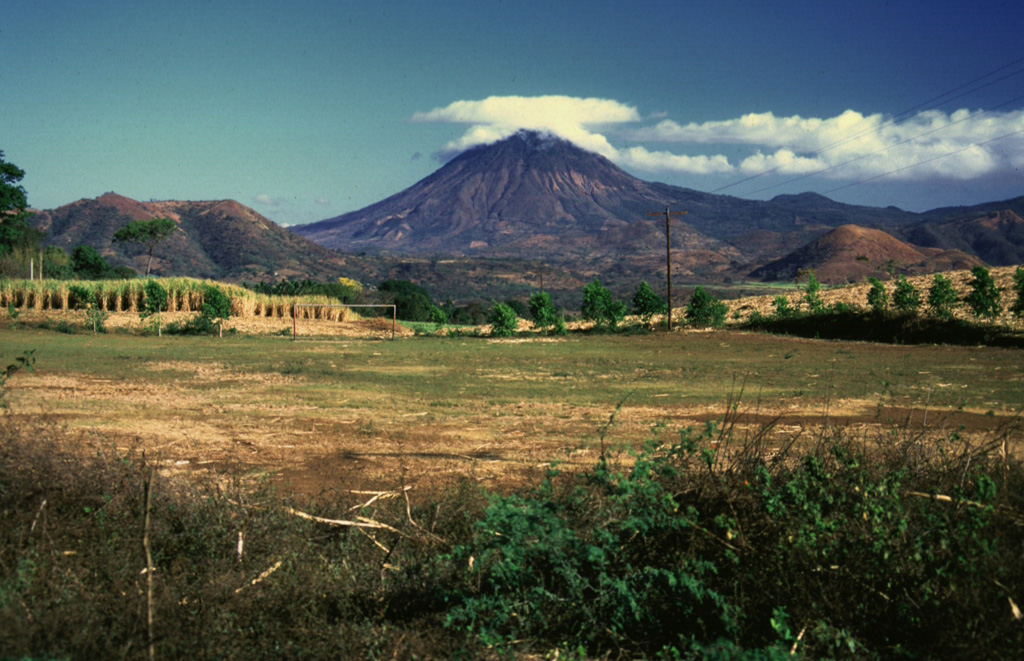 This view of Volcán Chingo from the SE side shows several smaller cones on the Salvador side of the volcano. Loma Los Siete Cerros is to the left, and the rounded cone of Cerro Laguneta to the right. Photo by Giuseppina Kysar, 1999 (Smithsonian Institution).