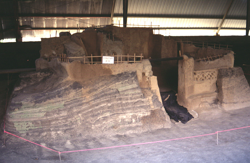 An excavation at the Joya de Cerén archaeological site in the Zapotitán Valley shows pyroclastic surge deposits from the 590 CE eruption of the Laguna Caldera scoria cone against Mayan buildings. The excavation has unearthed several small Protoclassic Mayan homesteads that were buried by this eruption on the northern flank of San Salvador. They contain the remains of uneaten meals left by occupants who evacuated their houses. Photo by Giuseppina Kysar, 1999 (Smithsonian Institution).