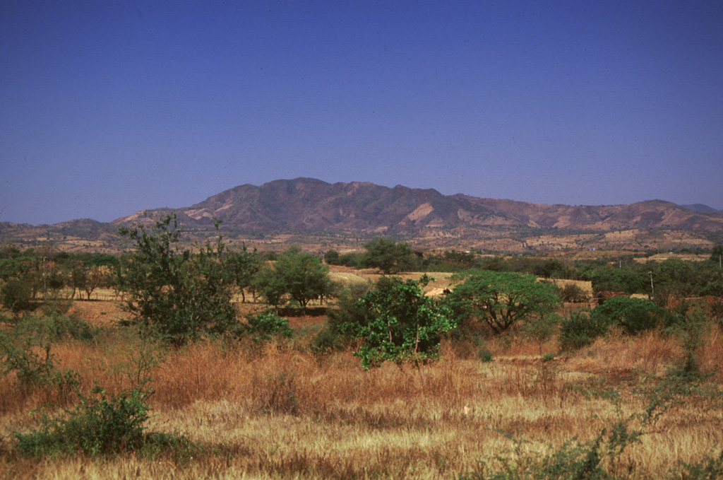 Cerro Juana Pancha, seen from the south near the Pan-American highway on the way to La Unión, is part of the Pleistocene Cerro Yayantique volcanic field.  Cerro Yayantique is the most prominent and least-eroded  feature in a broad area of Pleistocene volcanic rocks in the SE corner of El Salvador west of the NW arm of the Gulf of Fonseca.  An E-W-trending area of smaller Pleistocene volcanic cones to the NE straddles both sides of the Río Amatillo Sirama. Photo by Giuseppina Kysar, 1999 (Smithsonian Institution).