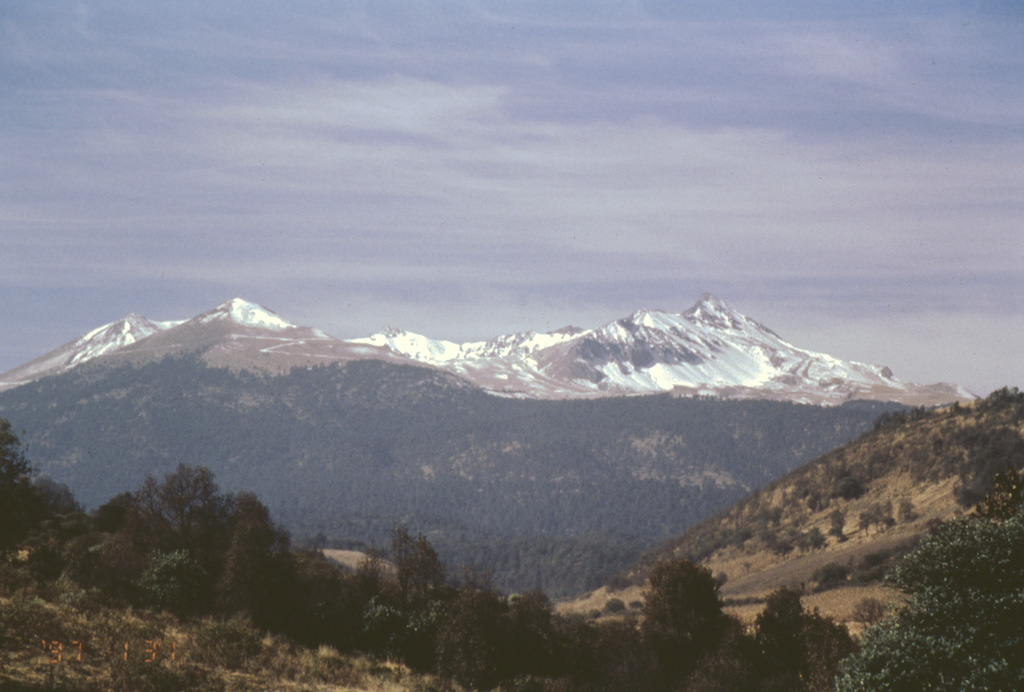 Nevado de Toluca is a broad edifice with a 1.5-km-wide summit crater that opens to the east. The northern flank rises here above the Zacango valley with a thin covering of summit snow. Two explosive eruptions during the late Pleistocene produced widespread ashfall and pyroclastic flow deposits. More recent work has revealed evidence for at least one Holocene eruption, about 3,300 years ago. Photo by José Macías, 1997 (Universidad Nacional Autónoma de México).