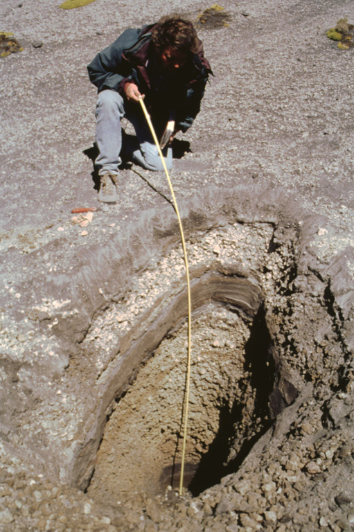 A trench dug on the flank of the Popocatépetl above the tree line at 4 km exposes deposits of a major explosive eruption. Volcanologist Claus Siebe from the National University of Mexico is measuring the thickness of an alternating sequence of ashfall and pyroclastic surge deposits produced during a Plinian eruption of the volcano about 1,100 years ago. Following this major eruption, lahars from accumulated ashfall deposits on the slopes of Popocatépetl and Iztaccíhuatl flooded the Puebla basin. Photo by José Macías, 1998 (Universidad Nacional Autónoma de México).