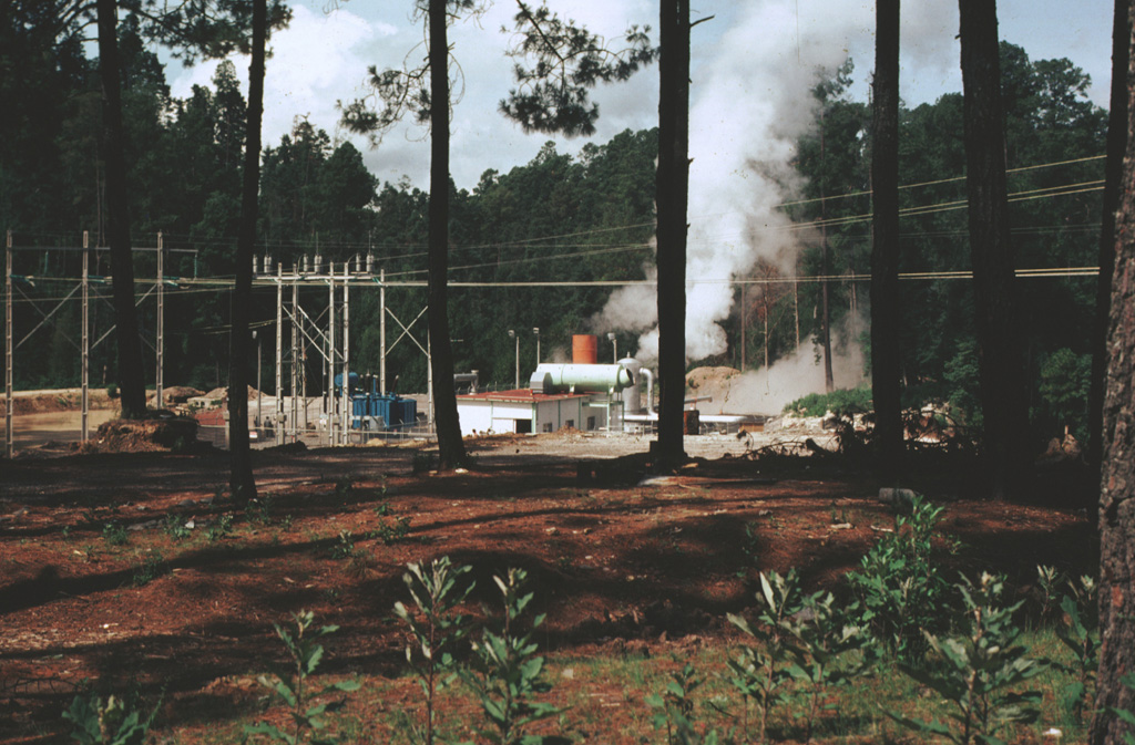 Los Azufres geothermal field began producing electricity in 1982, the year this photo was taken. The power plant at well AZ-6 shown here is located in the southern (Tejamaniles) section of the field. Surface exposures here consist of the roughly 1-million-year-old Agua Fria rhyolite rocks. Exploratory drilling began at Los Azufres in 1976, and 67 wells had been drilled by 1998 in an area of 60 km2, of which 33 were producing electricity. Photo by Pat Dobson, 1982 (Lawrence Berkeley National Laboratory).