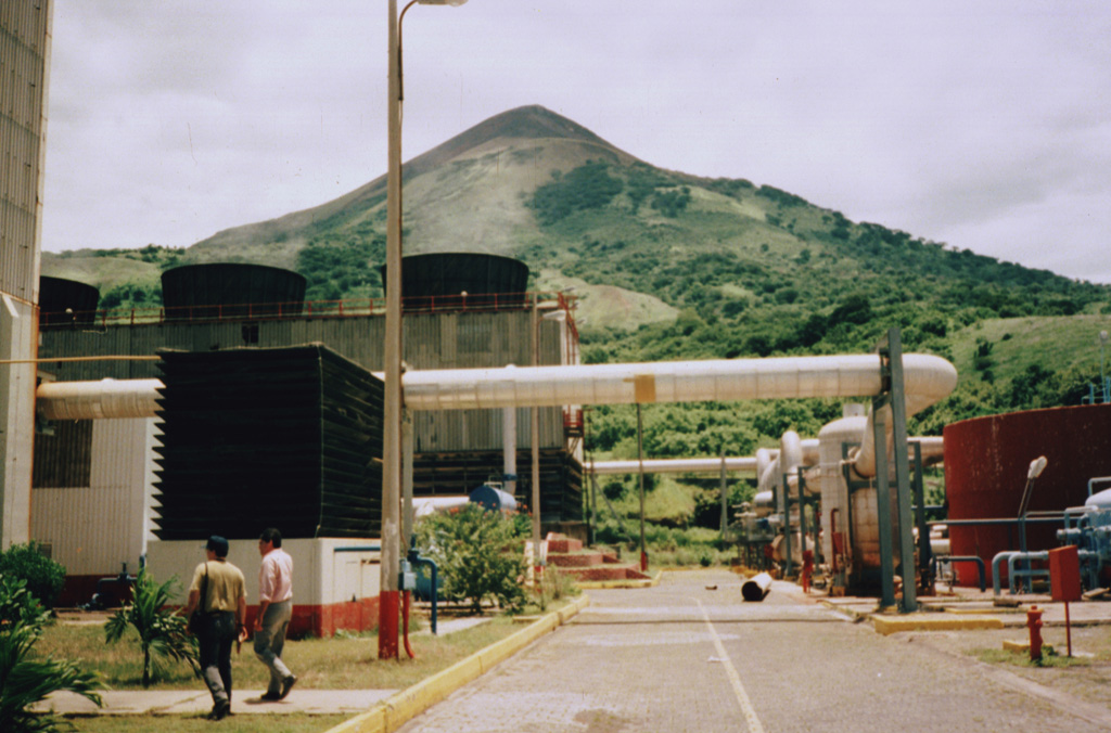 The Momotombo geothermal area, located near the shores of Lake Managua at the southern foot of the volcano, was identified and studied starting in the late 1960s.  The first four wells were drilled in the early 1970s, culminating with the installation of a 35 MWe unit in 1983.  Six years later, a second unit of 35 MWe went on line.  After a period of declining output in the 1980s and 1990s due to overexploitation and lack of reinjection, the power output at Momotombo was restored to about 35 MWe by 2002. Photo by Pat Dobson, 1996 (Lawrence Berkeley National Laboratory).
