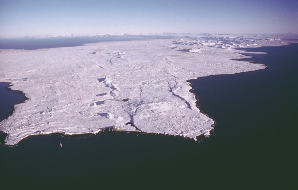 The snow-covered Reykjanes volcanic system forms the SW tip of the Reykjanes Peninsula, where the Mid-Atlantic Ridge rises above sea level. It is the westernmost of a series of four closely spaced, NE-SW-trending, en-echelon fissure systems that extend diagonally across the Reykjanes Peninsula. Most of this system is covered by Holocene lavas, and eruptions occurred during the 13th century at several locations. Photo by Oddur Sigurdsson, 1998 (Icelandic National Energy Authority).