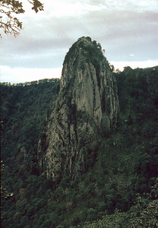 The dramatic spine in the summit crater of Tequila volcano rises 300 m above the crater floor.  The dacitic spine, similar to the one at Sangangüey volcano, has been dated at 210,000 years and occupies a summit depression that is breached to the NE.  The spine appears to represent the latest activity from the central vent of Tequila. Photo by Paul Wallace, 1990 (University of California Berkeley).