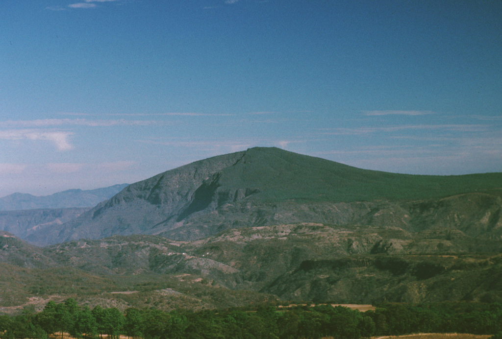 Cerro La Cienega is a broad andesitic shield volcano that lies east of the Atenguillo river near the center of the Northern Atenguillo volcanic field.  It is one of three Pliocene andesitic centers in the volcanic field, which also includes the La Laja shield volcano and the El Rosario lava plateau of Pleistocene age. Photo by Paul Wallace, 1998 (University of California Berkeley).