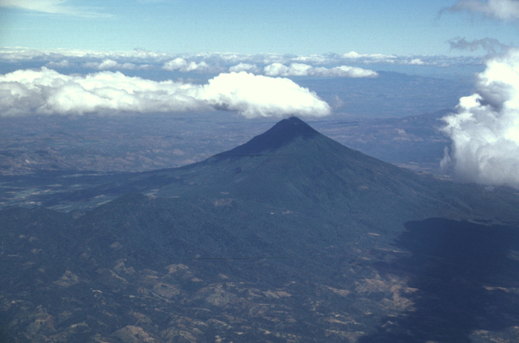 San Vicente rises about 2 km above the Pacific coastal plain of El Salvador. The volcano has formed within the Pleistocene La Carbonera caldera and has buried the eastern caldera rim. The edifice and caldera are within the 20-30 km wide Central Graben within Tertiary volcanic basement rocks. Photo by Lee Siebert, 1999 (Smithsonian Institution).