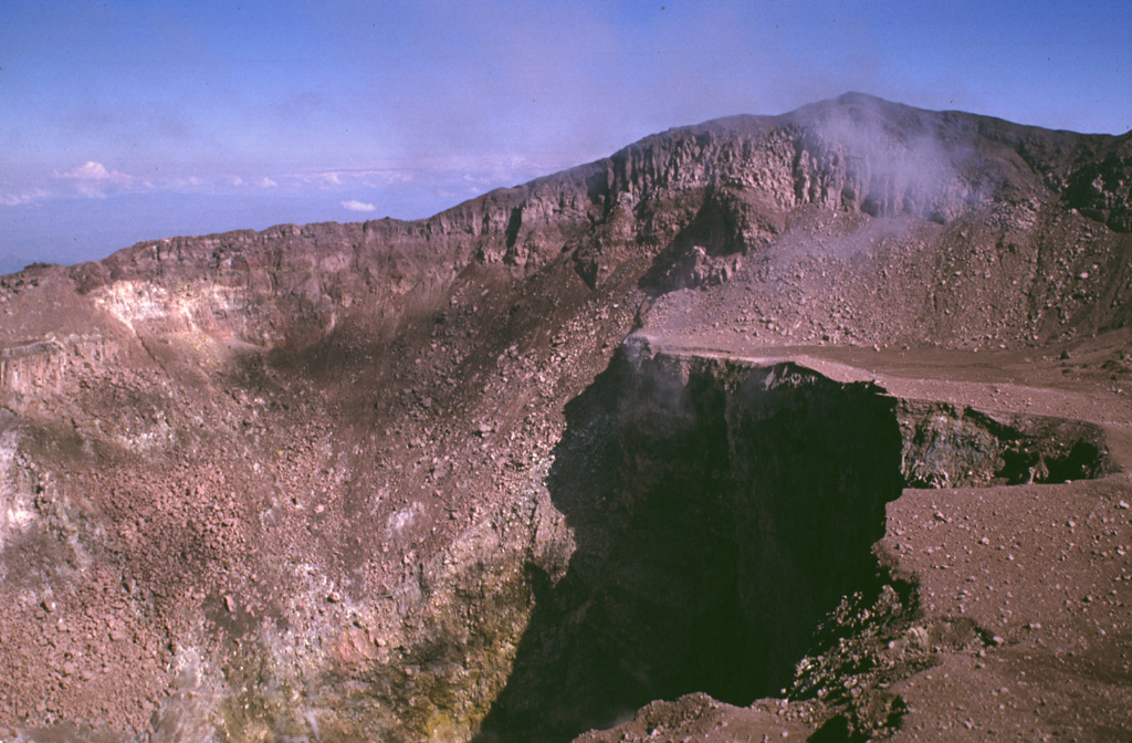 This view from the southern crater rim shows the 2030 m high point of San Miguel on the NE rim at the upper right.  An ejecta-covered terrace on the eastern side of the crater is truncated by a deep inner crater.  The crater morphology has varied dramatically since the beginning of documentation in the 16th century.  In 1866 a 600-m-wide, 320-m-deep crater existed in the SE part of the summit crater, while a 100-m-wide, 80-m-deep adventive crater was located in its ENE part. Photo by Lee Siebert, 1999 (Smithsonian Institution).