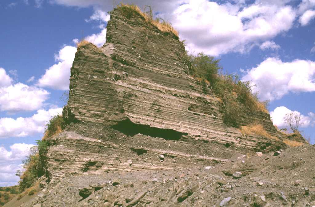 A quarry at Laguna de Aramuaca exposes a roughly 10-m-high section of thinly bedded pyroclastic-surge layers.  Despite its immediate proximity to the Pan-American highway, this spectacular maar remains to be studied in detail. Photo by Lee Siebert, 1999 (Smithsonian Institution).