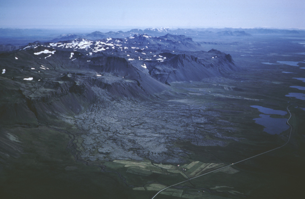 An aerial view looking east down the Snæfellsnes Peninsula shows the Bláfeldarhraun lava flow in the foreground. The cone that produced it is part of the Helgrindur (Lýsuskarð) volcanic system, which consists of small scoria cones and vents along a WNW-ESE trend across the central Snæfellsnes Peninsula. Photo by Oddur Sigurdsson, 1983 (Icelandic National Energy Authority).