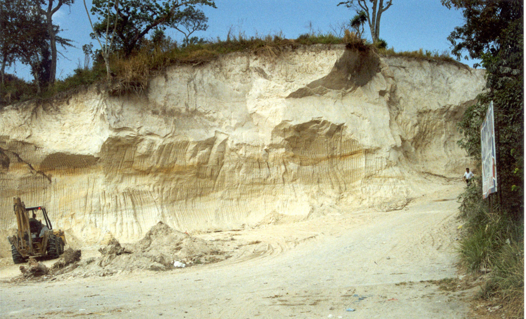Pyroclastic flow and ashfall deposits from Ilopango caldera, known collectively as Tierra Blanca (White Soil), are found over much of central and western El Salvador. This quarry near the city of Cojutepeque (9 km ENE of the caldera) exposes the Tierra Blanca Joven (TBJ) formation that was produced during the youngest of several Tierra Blanca eruptions about 1,500 years ago. The eruption destroyed early Mayan cities and resulted in their abandonment for decades to centuries. Photo by Giuseppina Kysar, 1999 (Smithsonian Institution).