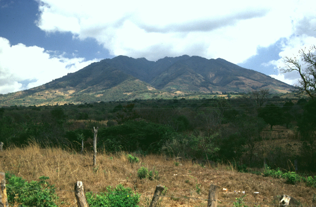 The irregular summit ridge of Volcán Suchitán is seen here from the SSW, west of the city of Asunción Mita. The edifice is extensively eroded, and large gullies descent its slopes. Two lava flows of estimated Holocene age were erupted from vents on the N and NW flanks. Photo by Giuseppina Kysar, 1999 (Smithsonian Institution).