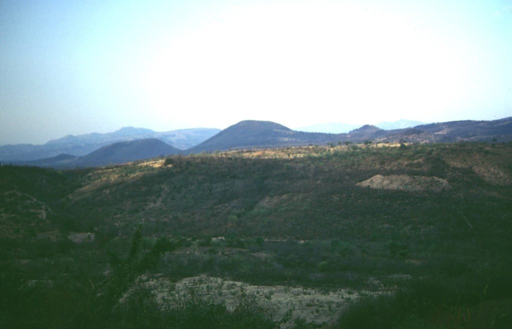 The youngest vents of the Chiquimula volcanic field were erupted along a N-S-trending fracture north of the town of Chiquimula. They are seen here from the NE. The youngest lava flows originated from vents at Cerro Chiquito.  Photo by Giuseppina Kysar, 1999 (Smithsonian Institution).