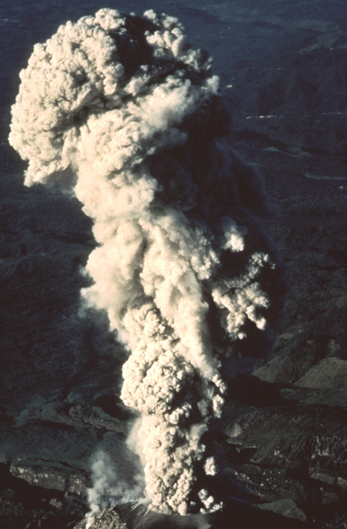 The summit of Santa María provides this vantage point for viewing eruptions of the Santiaguito lava dome. This February 1988 ash plume rose from the vent to a height slightly above the summit. The brief 1-2 minute explosions produced light ashfall to within about 6 km of the vent. Photo by Jon Fink, Arizona State University, 1988 (courtesy of Bill Rose, Michigan Technological University).