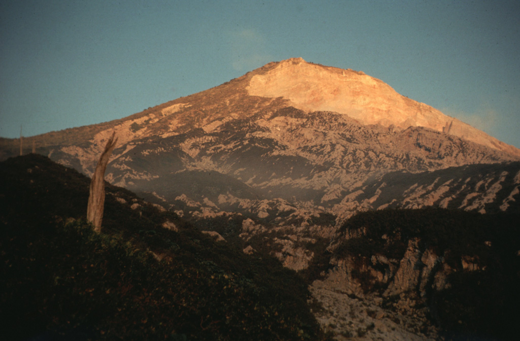 The Santa María western flank of is seen here at sunset. The light-colored area to the upper right is the upper headwall of the 1902 explosion crater across the SW flank.  Pumice deposits from the 1902 eruption are visible across the flanks, exceeding 15 m in thickness. Photo by Bill Rose, 1970 (Michigan Technological University).