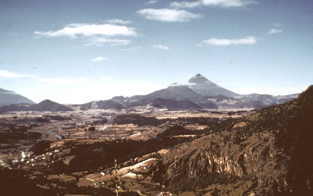 The line of low-elevation forested lava domes in the center of the photo are a chain of domes erupted along the rim of a Pleistocene caldera of the Almolonga complex. The highest dome, Cerro Quemado, is the peak seen here from the north below and to the left of Santa María, the highest peak in this photo. A 3.3-km-wide caldera formed within the field sometime prior to 85,000 years ago. Post-caldera eruptions produced eight lava domes. Photo by Bill Rose, 1973 (Michigan Technological University).