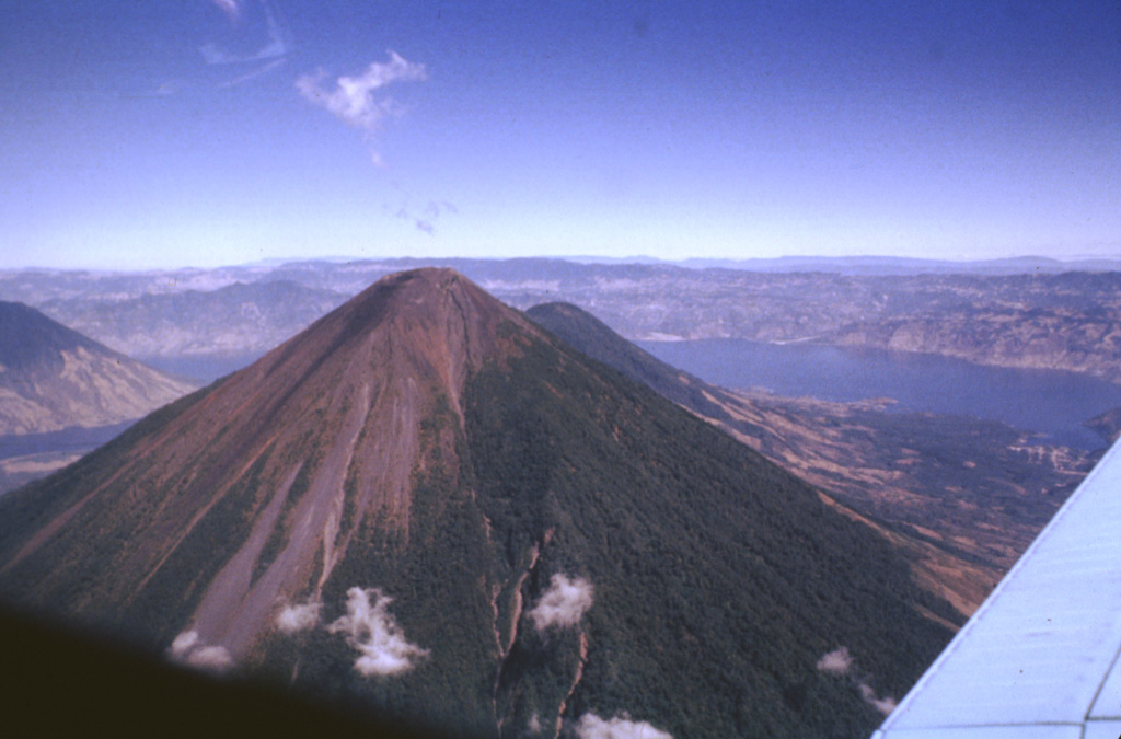 Volcán Atitlán directly overlies the inferred margin of the Pleistocene Atitlán III caldera, whose northern rim lies across Lake Atitlán. The Atitlán stratovolcano is adjacent to Tolimán to its north (seen just to the right of Atitlán's summit). The historically active Atitlán is younger than Tolimán, although their earlier activity overlapped. Atitlán’s surface is composed of tephra, reflecting its predominantly explosive eruptions that have been recorded since the 15th century. Photo by Bill Rose, 1980 (Michigan Technological University).